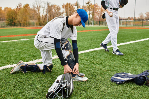 Two enthusiastic teens sharpen their baseball skills on a well-maintained field, full of life.