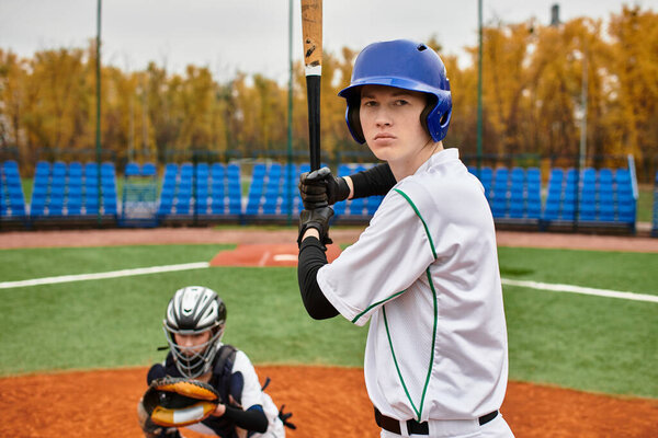 Two teenage boys play baseball on a lively field filled with energy and youthful enthusiasm.