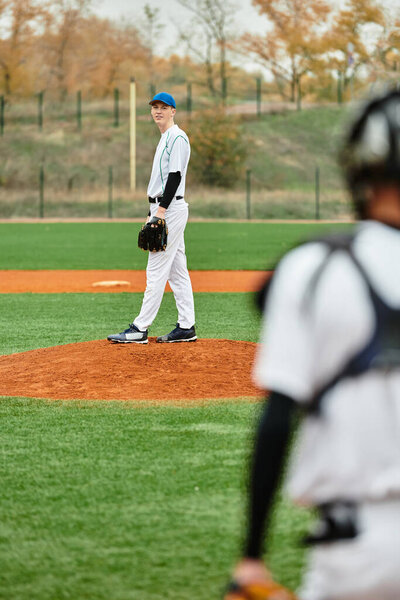 Two energetic teens compete in a lively baseball game, showcasing teamwork and skill.