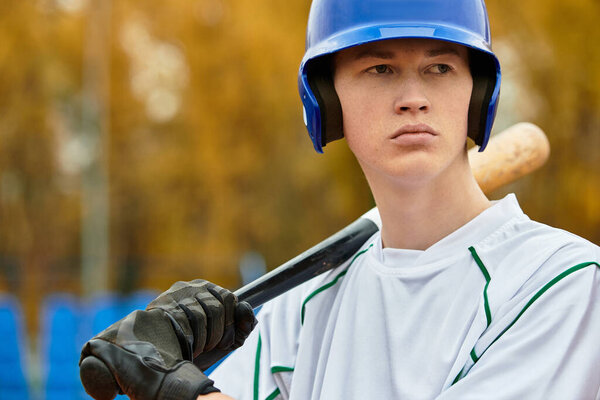 A skilled player grips his bat, focused and poised for the next play in baseball practice.