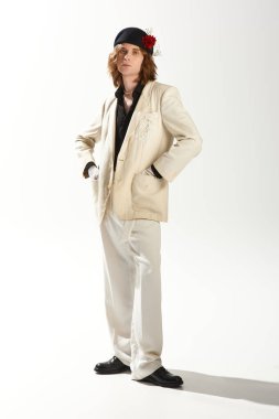 Şık, büyük spor ceketli yakışıklı bir adam kendine güvenen bir şekilde poz veriyor..