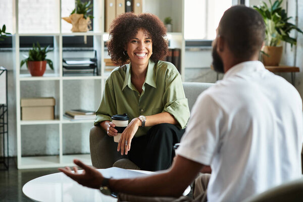Two young professionals connect in a bright studio, sharing job aspirations and opportunities.