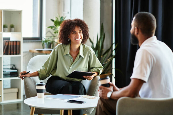 Two young professionals discuss job opportunities in a modern studio atmosphere.