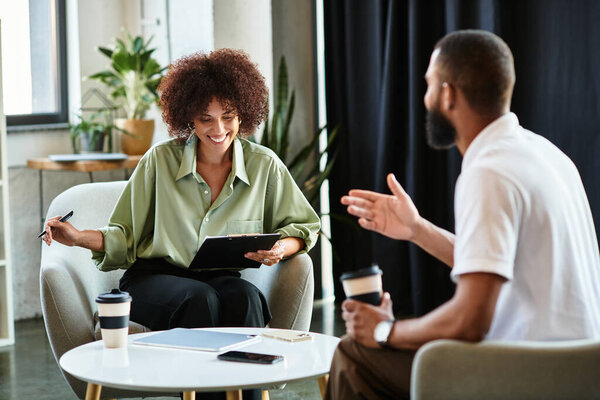Two young professionals share a moment during a interview in a stylish studio setting.