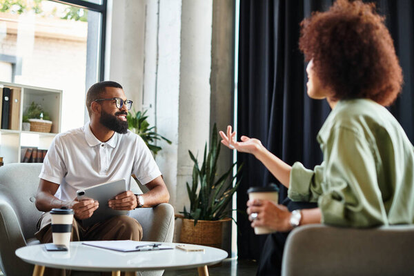 A young man and woman conducting interview in a stylish studio environment.