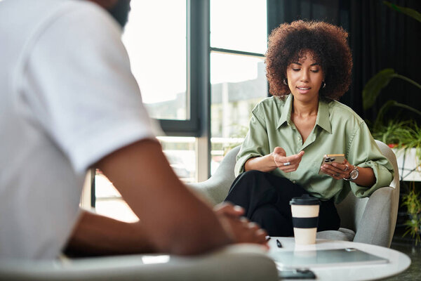 Two young professionals participate in an important interview in a sleek studio environment.