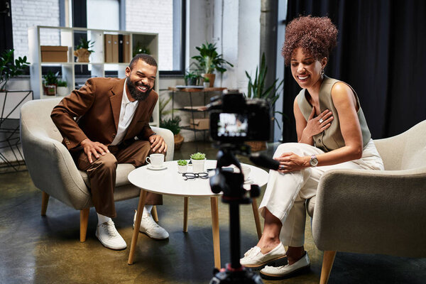 Young man and woman participate in a lively interview in a contemporary studio.