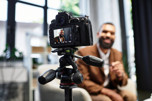Young man smiles confidently while being interviewed by a woman in a stylish studio.