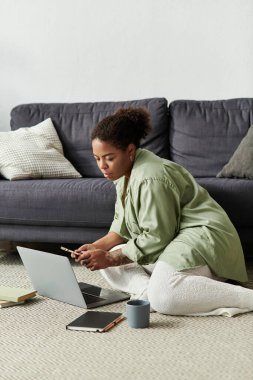 Günlük giysiler içindeki Afrikalı Amerikalı bir kadın evdeki serbest işlerinde çalışıyor..