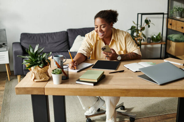 An african american woman engages in remote work at her comfortable apartment, smiling and focused.