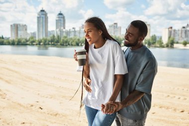 Sevgi dolu çiftler birlikte su kenarında dolaşır, birlikte vakit geçirirler ve güzel havanın tadını çıkarırlar..