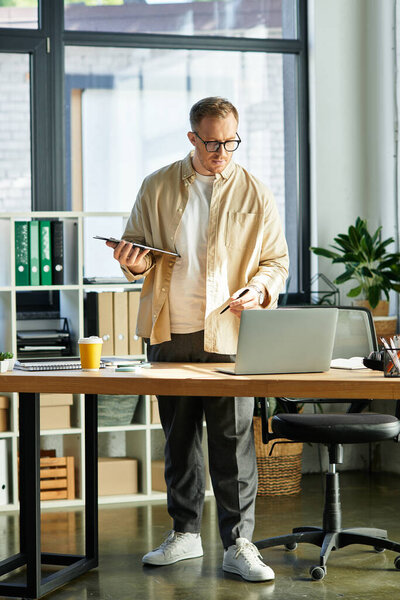 A stylish young professional balances productivity and comfort at his office desk.