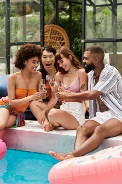 Dört arkadaş keyifli bir havuz partisinde kadeh kaldırır..