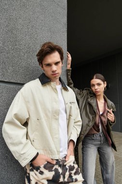 Genç bir çift, şık bir arka plana karşı sevgi dolu pozlar verir..