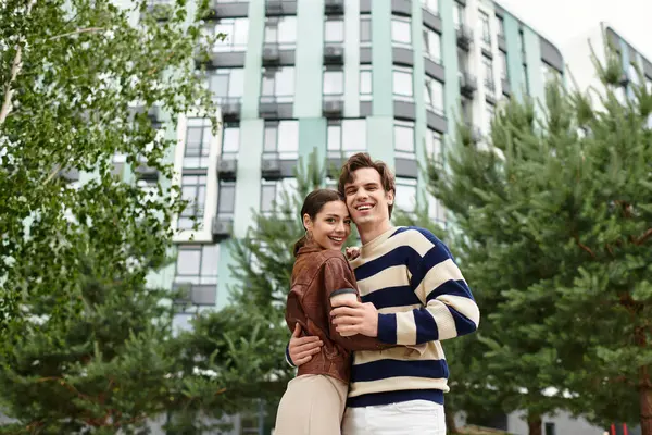 Sevgi dolu çift dışarıda kucaklaşır, şık bir şehir ortamında birbirlerine eşlik ederek eğlenirler..