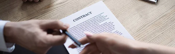 Top view of contract near businessman and candidate holding pen in office, banner — Stock Photo