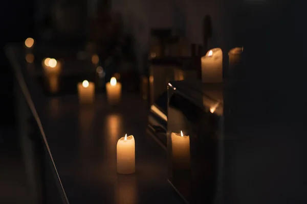 Dark kitchen with candles burning on worktop during energy blackout — Stock Photo