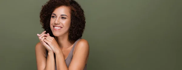 Pretty african american woman in top looking away isolated on green, banner — Stock Photo