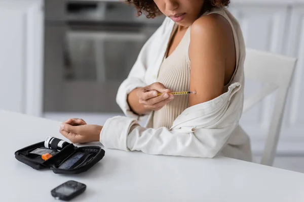 Cropped view of diabetes kit near african american woman doing insulin injection at home — Stock Photo
