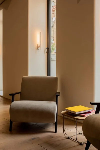 Modern armchairs near books on coffee table in luxury hotel lobby — Photo de stock
