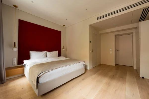 Comfortable bed with white pillows in modern hotel room - foto de stock