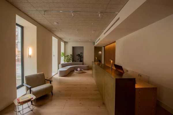 Interior of luxury hotel lobby with reception desk near modern sofa and armchair — Stock Photo