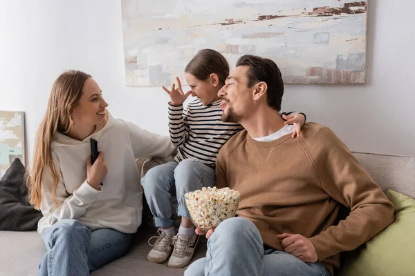 Happy father and child making fun while grimacing near mother at home — Foto stock