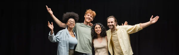 Troupe of smiling multicultural actors hugging and waving hands in theater, banner — стоковое фото