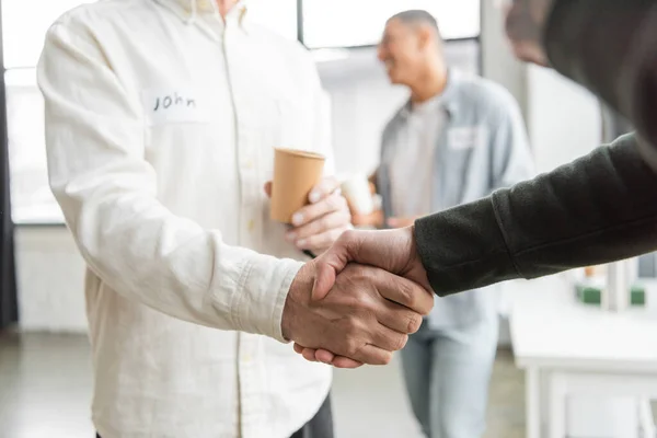 People with alcohol addiction shaking hands in recovery center — Stock Photo