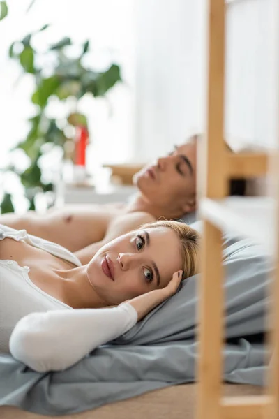 Confused blonde woman waking up with stranger man in her bed after one night stand — Stock Photo
