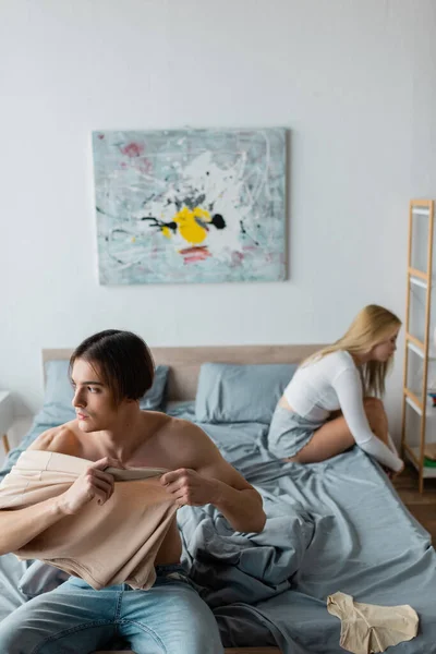 Young man and woman regretting of having one night stand in morning — Stock Photo