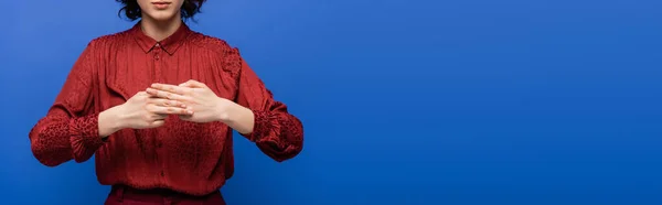 Cropped view of teacher showing gesture meaning name on sign language isolated on blue, banner — Stock Photo