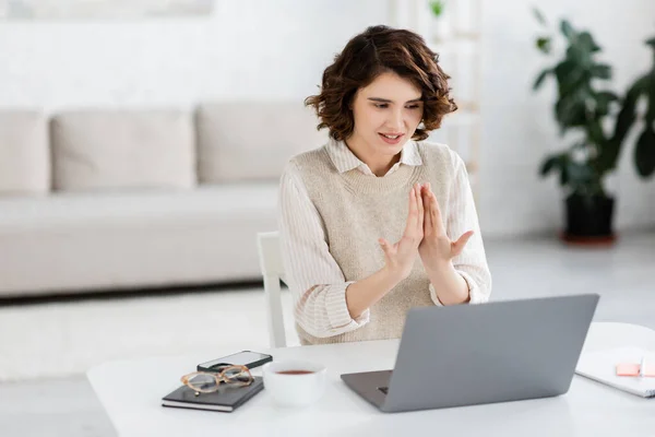 Positive sign language teacher with curly hair communicating during online lesson — Stock Photo