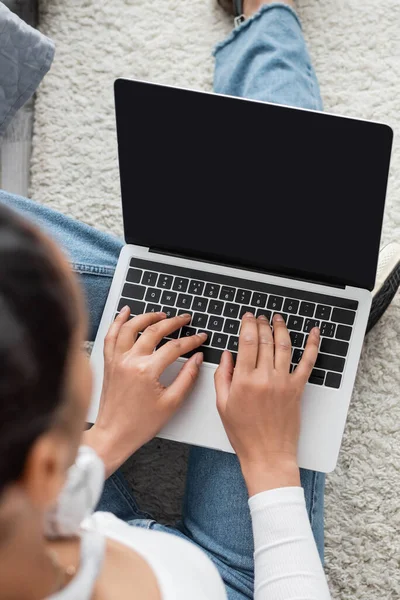 Top view of african american woman typing on laptop keyboard while studying from home — Stock Photo