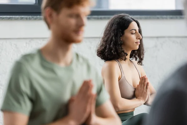 Middle eastern woman practicing anjali mudra in yoga group — Stock Photo
