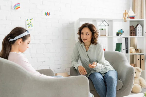 Psicólogo conversando com menina pré-adolescente descontente em consultório — Fotografia de Stock