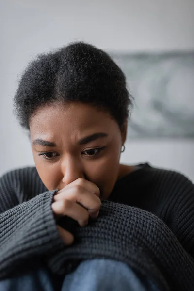 Portrait of young multiracial woman with depression looking away at home — Stock Photo