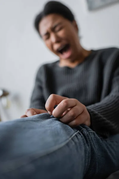 Blurred multiracial woman with mental problem crying at home — Stock Photo