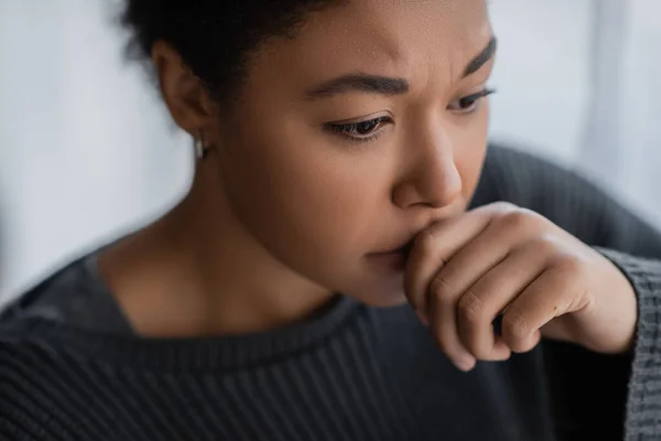 Portrait of upset multiracial woman with mental problem looking away at home — Stock Photo