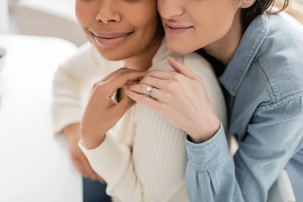 Partial view of engaged multiracial lesbian women with engagement ring hugging each other — Stock Photo