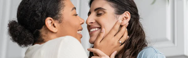 Overjoyed multiracial woman with engagement ring on finger hugging girlfriend, banner — Stock Photo