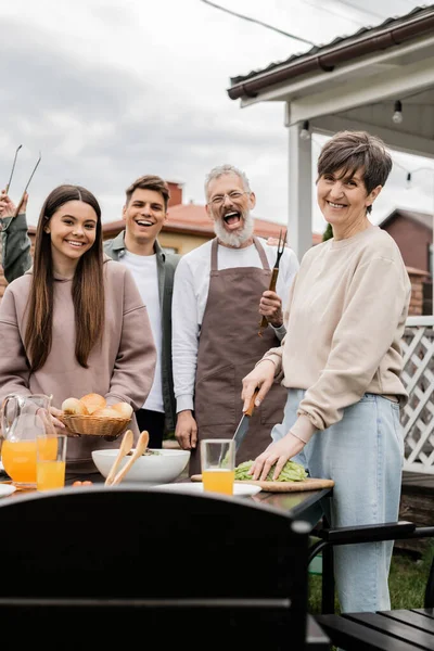 Family photo, excited and happy siblings near middle aged mom and dad, grill party, celebration of parents day concept, looking at camera on backyard of summer house, june — Stock Photo