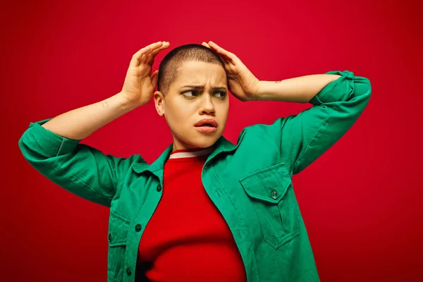 Fashion statement, curvy fashion, generation z, youth culture, upset young woman with short hair posing on red background, casual wear, youth culture, vibrant background, stylish appearance — Stock Photo