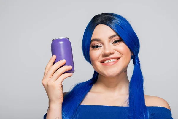 Concept d'été, jeune femme joyeuse avec les cheveux bleus tenant canette de soda sur fond gris, sous-culture moderne, individualisme, jeunesse et style de vie, couleur vibrante, expression de soi, identité unique — Photo de stock