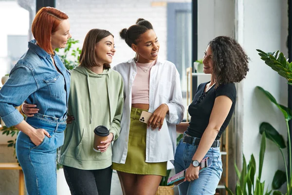 Joyful and stylish multiethnic women in stylish casual clothes looking at each other in friendly atmosphere of women interest club, mutual support, solidarity and trust concept — Stock Photo
