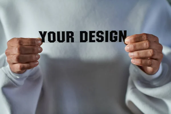 Cropped view of african american craftswoman in sweatshirt holding printing layer with your design lettering in print studio, focused business owner managing workshop — Stock Photo