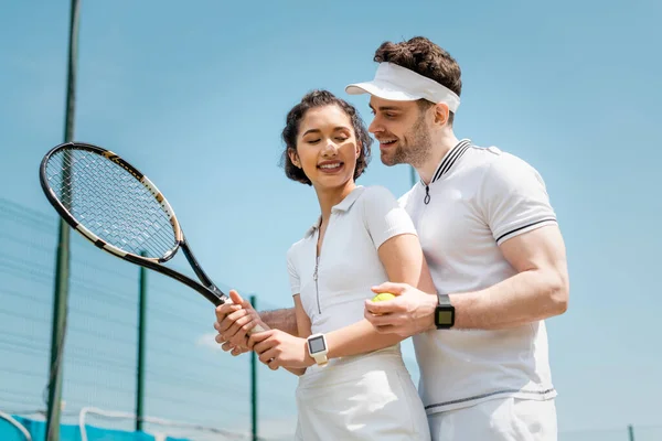 Summer romance and sport, banner, cheerful man teaching girlfriend how to play tennis on court — Stock Photo