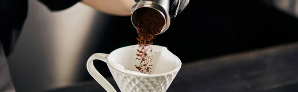Barista adding fine grind coffee from jigger into ceramic dripper, V-60 style espresso drip, banner — Stock Photo