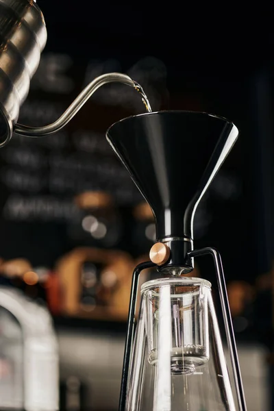 Siphon coffee maker and boiling water pouring from drip kettle during preparation, pour-over espresso — Stock Photo