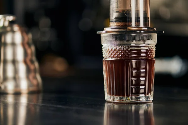 Kristallglas mit aromatischem und frisch gebrühtem Espresso, zubereitet in der Kaffeemaschine — Stockfoto